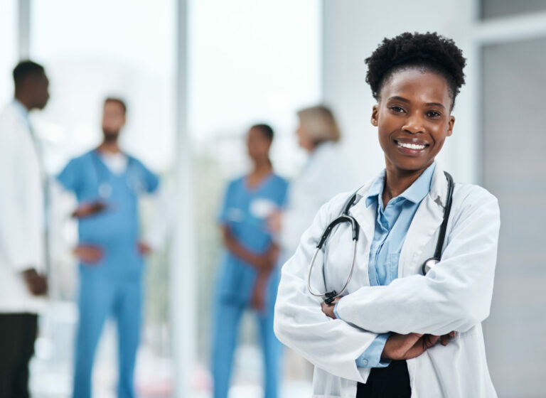 Portrait of a young doctor standing in a hospital.